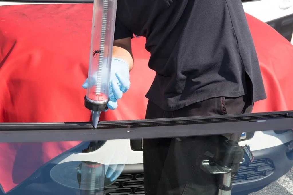 technician replacing windshield