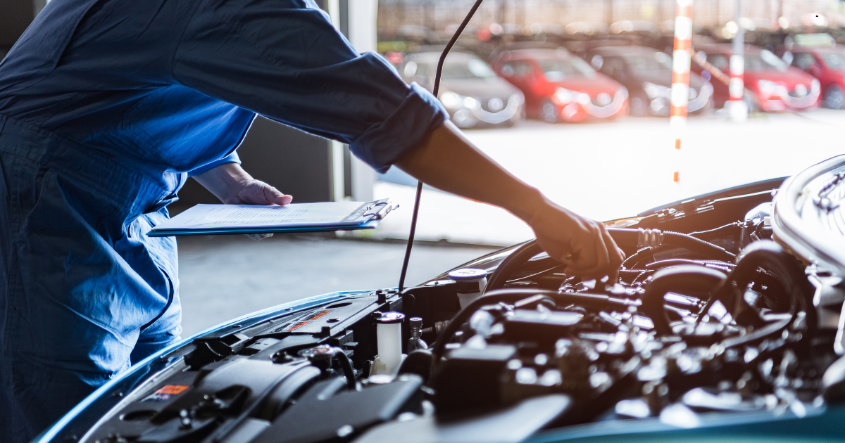 Mechanic checking car engine