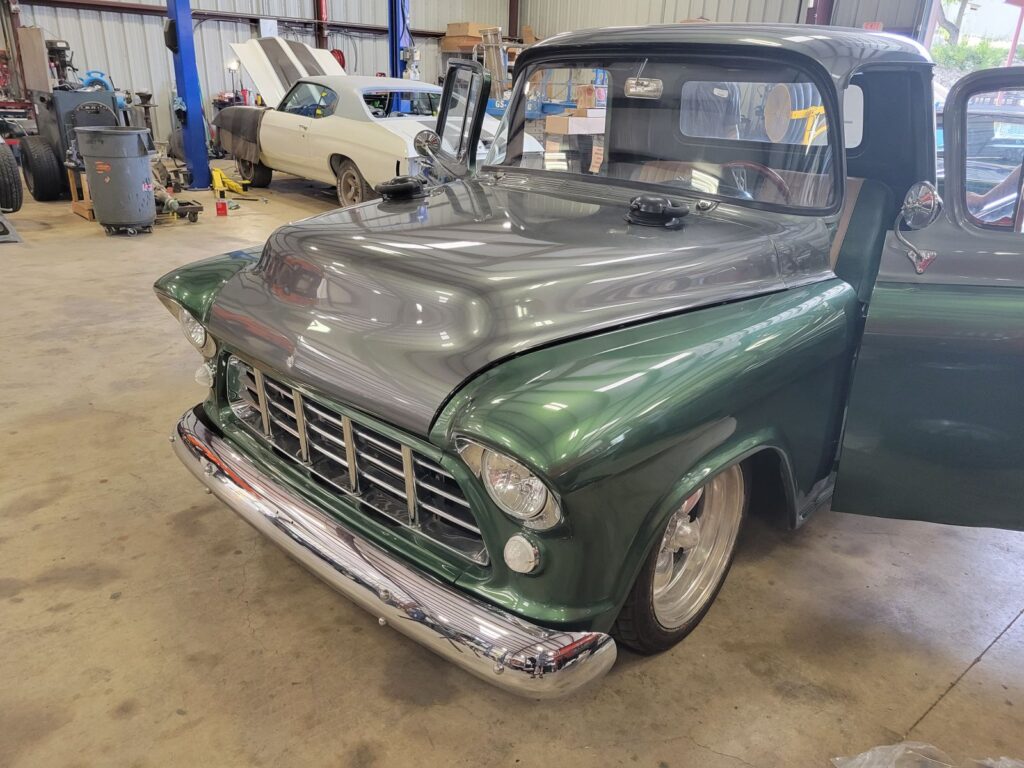 Green classic truck after windshield repair