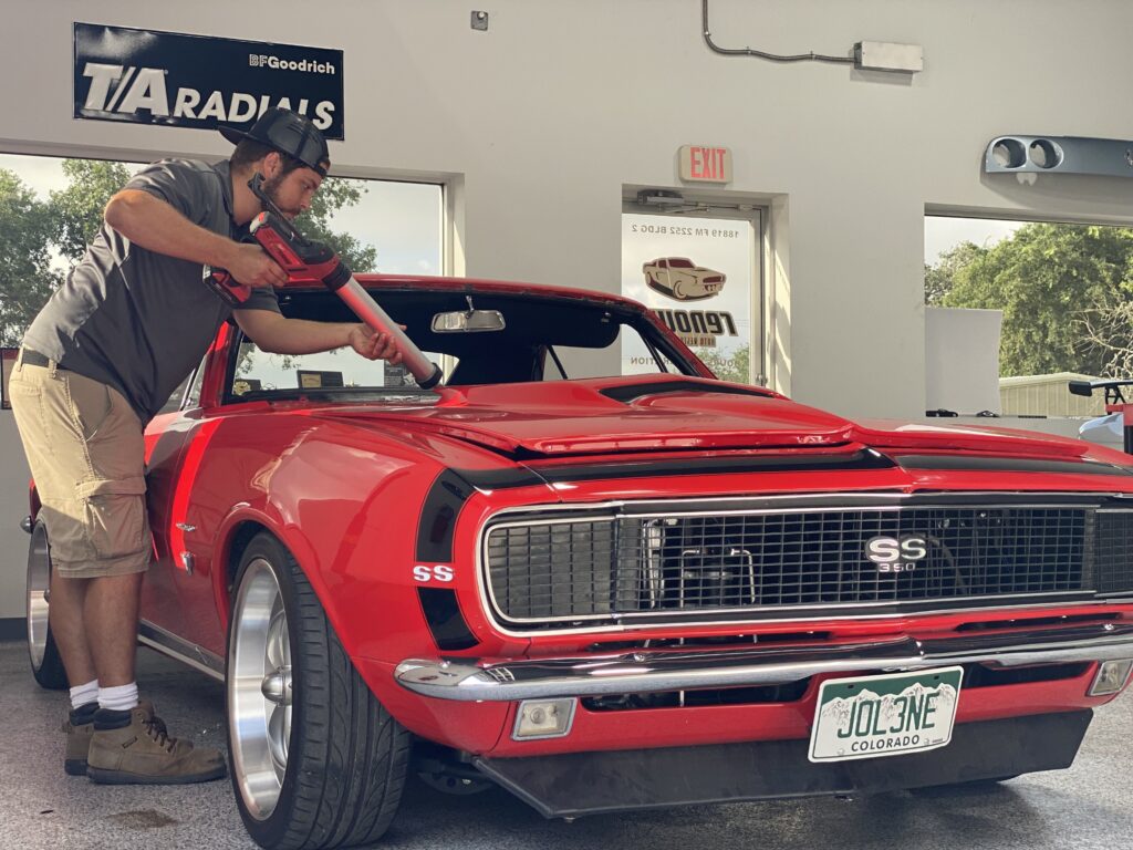 Auto glass technician replacing a car's windshield