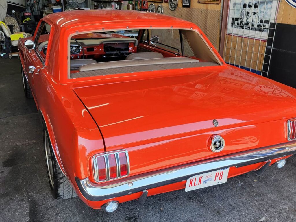 Red classic car without rear window glass